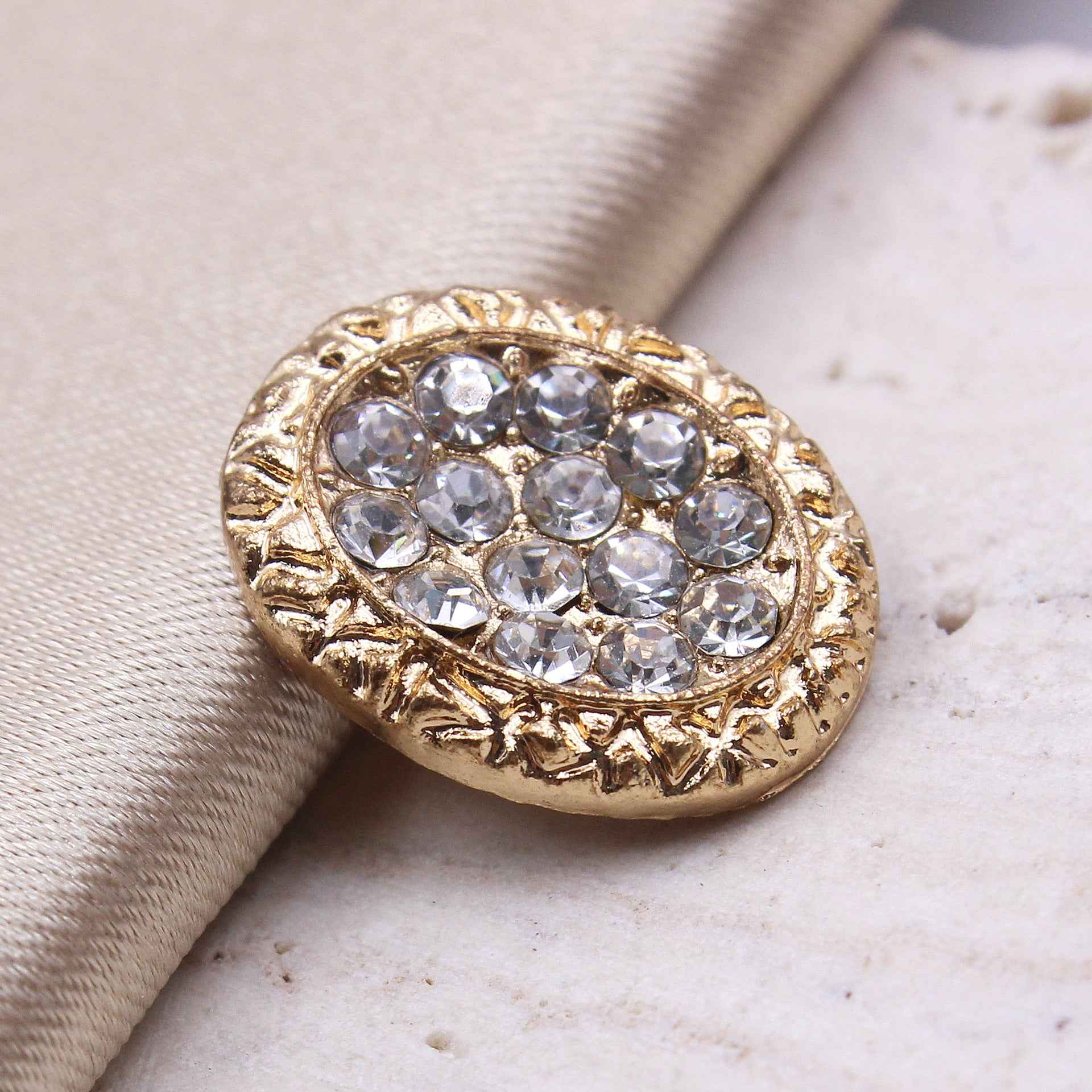 Gold oval rhinestone shank button with sparkling crystal details
