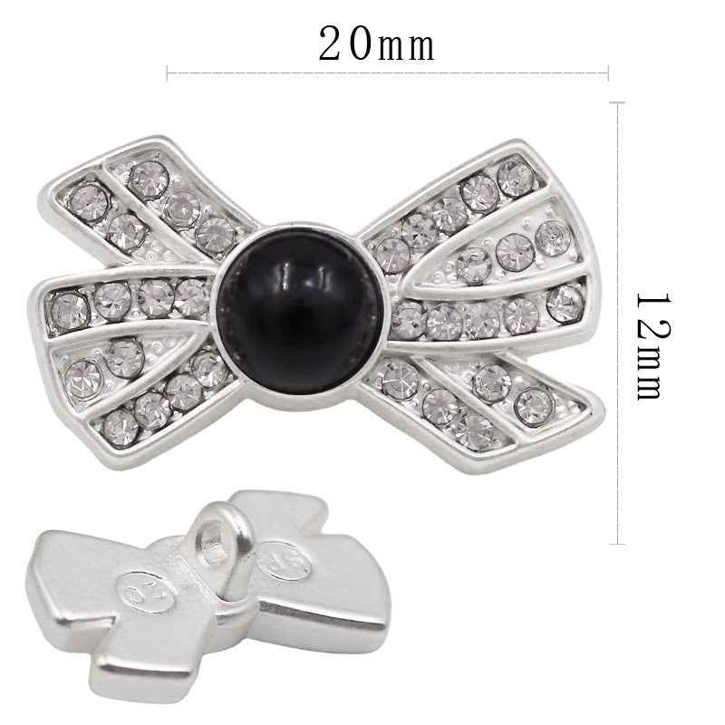 20x12mm bow-shaped rhinestone button, black pearl center, silver-tone setting