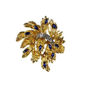 Gold-tone floral brooch pin with blue crystal accents and clear crystal band