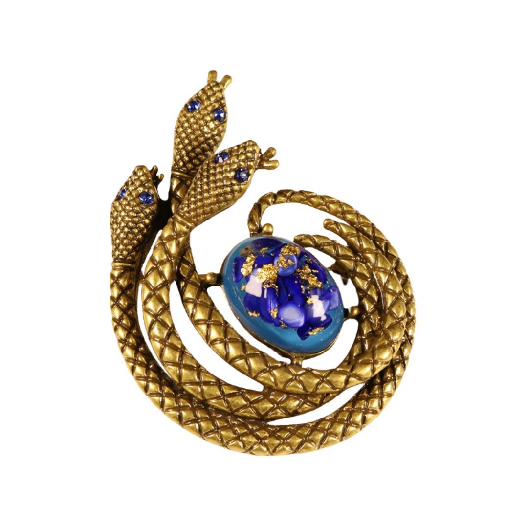Vintage gold tri-head brooch with blue glass cabochon and textured frame