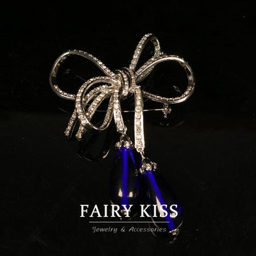 Copper bow brooch with rhinestones and blue glass drops, silver-tone setting