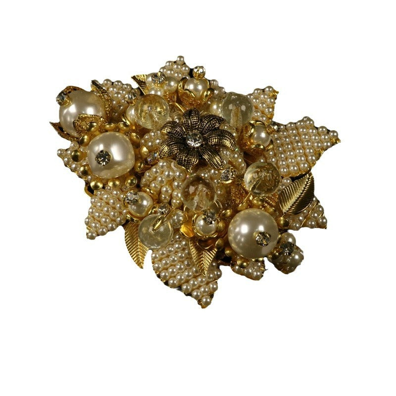 Gold beaded flower brooch with faux pearls, glass stones, and leaf accents.