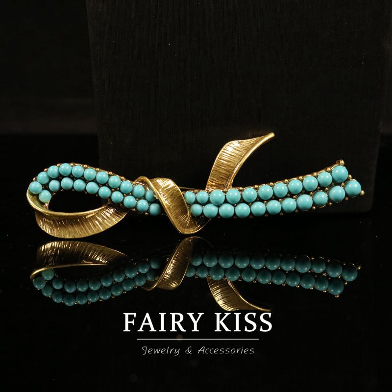 Gold-tone geometric brooch with turquoise bead strands and arched center