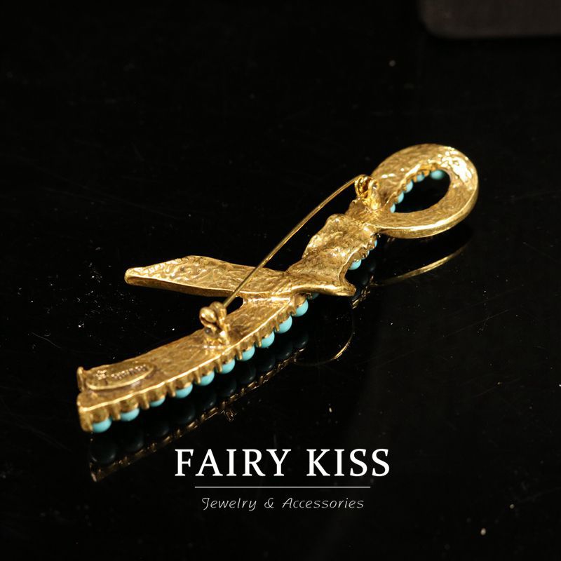 Gold-toned pin closure brooch with turquoise bead row and loop bail