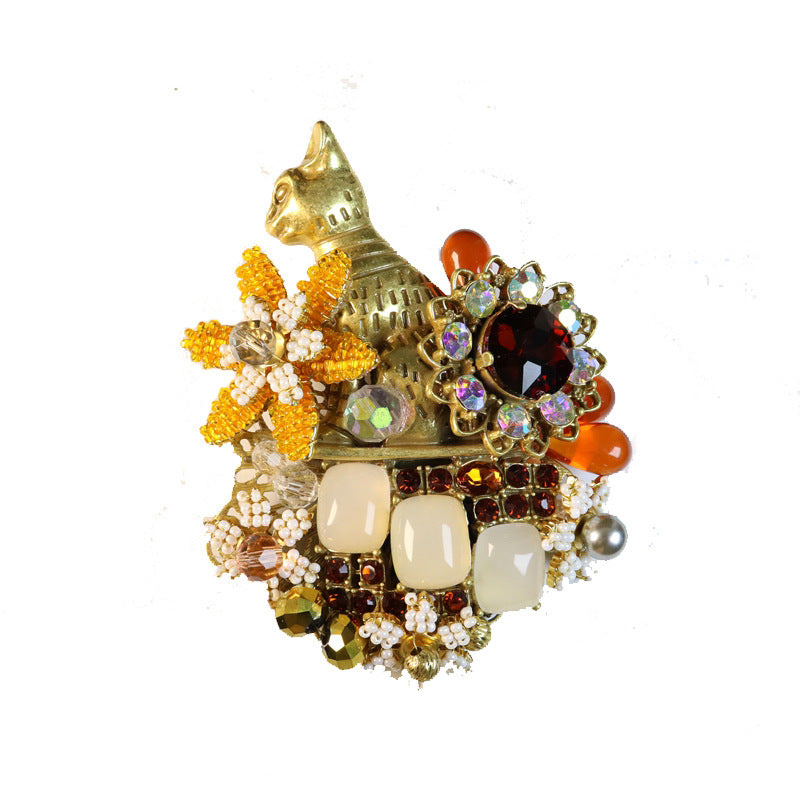 Vintage cat brooch with gold enamel body, beaded flower design and rhinestone accents