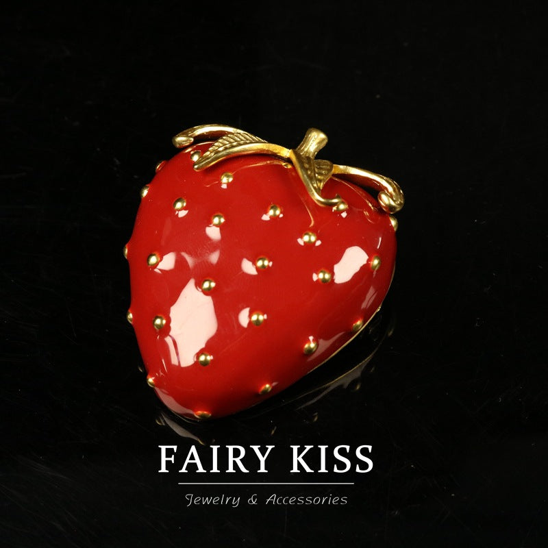 Red enamel strawberry brooch with gold-tone leaves and seed details