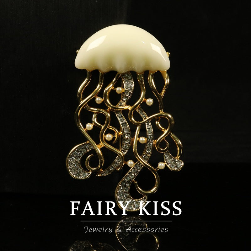 Jellyfish diamond-encrusted metal brooch with white dome, dangling pearls, and stones