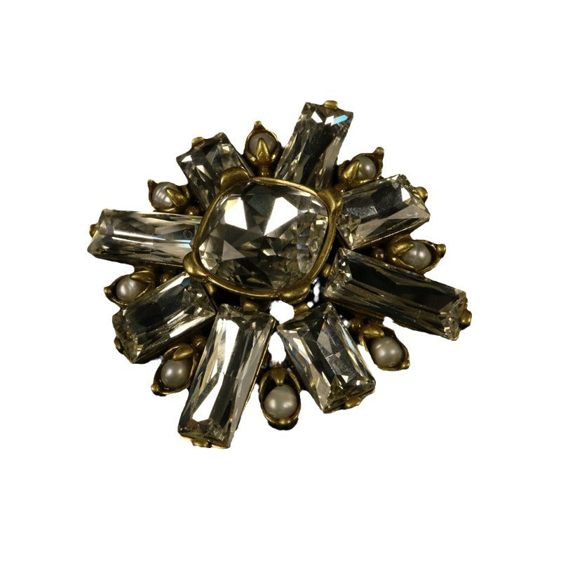Minimalist geometric rhinestone brooch with gold-toned setting and clear center stone