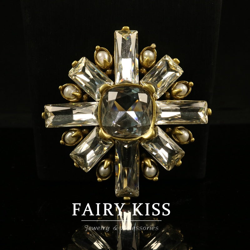 Gold-tone vintage geometric brooch with oval center stone and faceted crystal rays