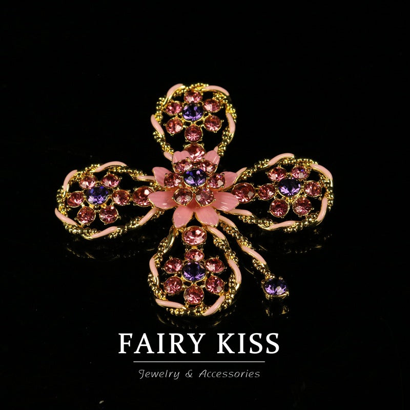 Pink enamel hollow flower brooch with gold-tone filigree and pink crystal centers