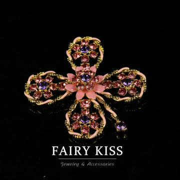 Pink enamel hollow flower brooch with gold-tone filigree and pink crystal centers