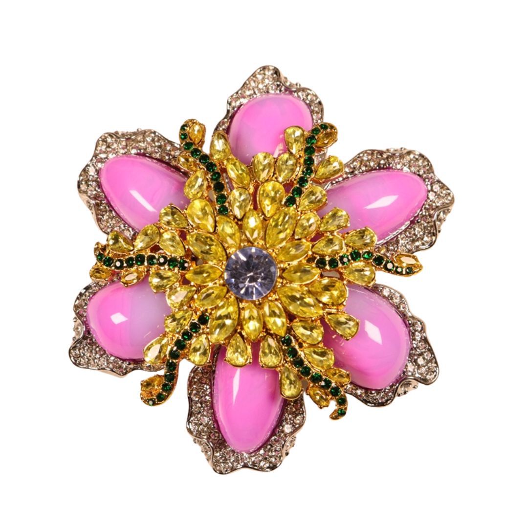 Pink rhinestone floral brooch with gold electroplated setting, green accents, blue center