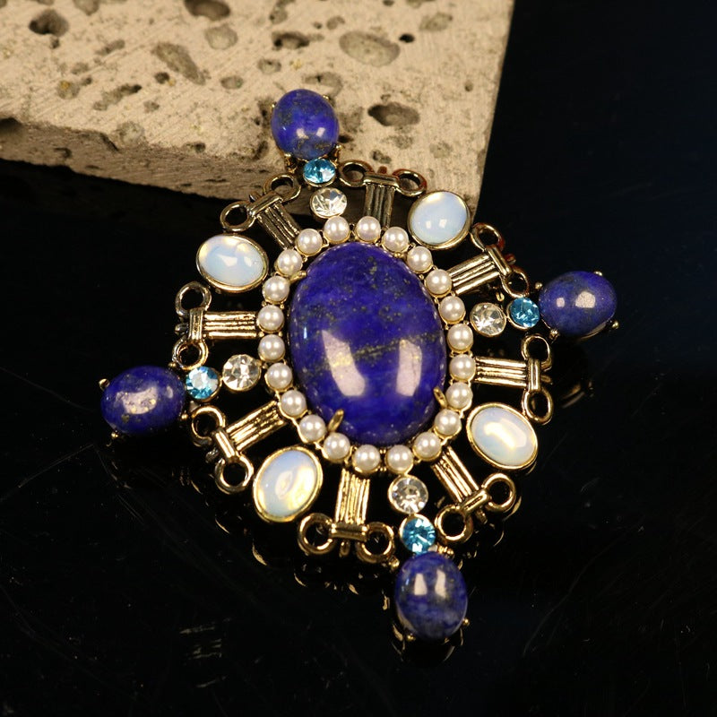 Blue lapis lazuli oval cabochon brooch with pearl strands, opal-toned insets, crystals