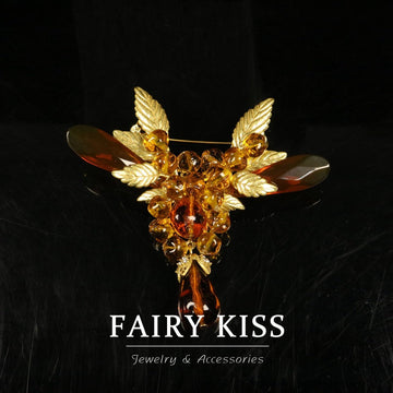 Vintage winged amber bead brooch with gold-tone leaf wings