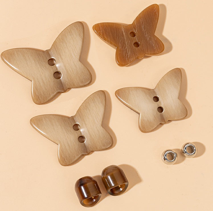 Set of khaki butterfly resin buttons with two-hole fronts and metal backs