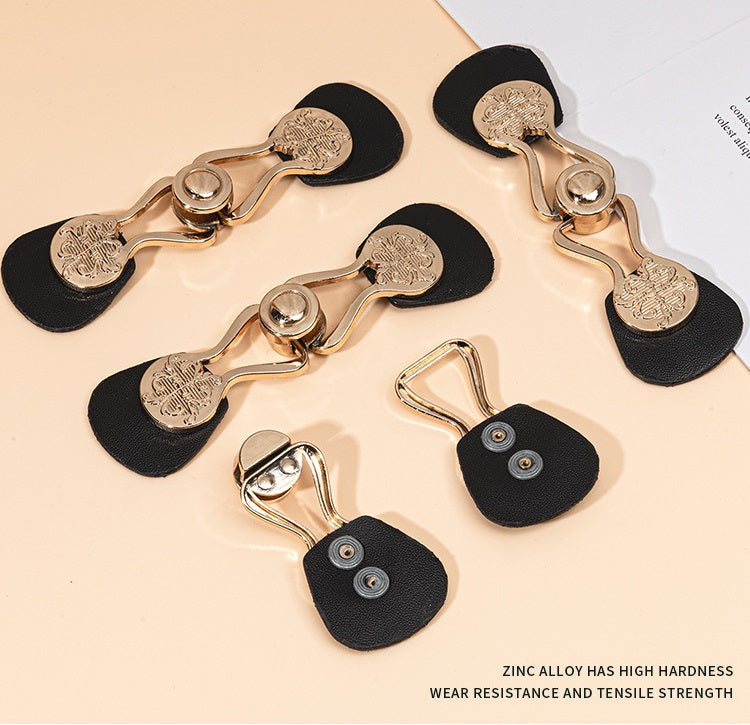 Six black leather toggle buttons with gold-tone rings and engraved metal ends