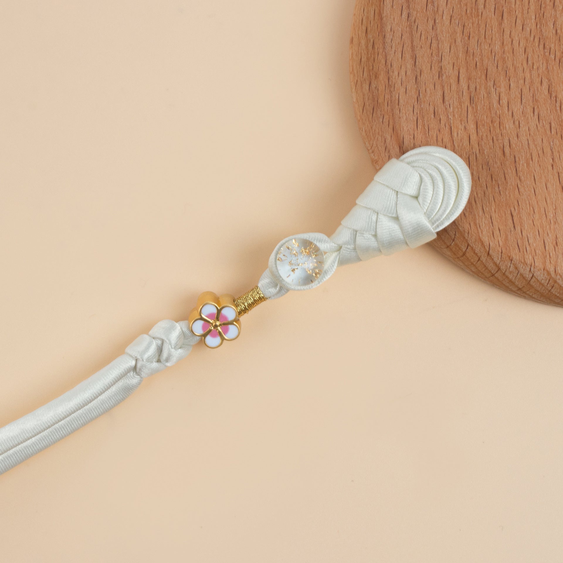 White braided frog button strand with gold flower charm and sparkly round bead