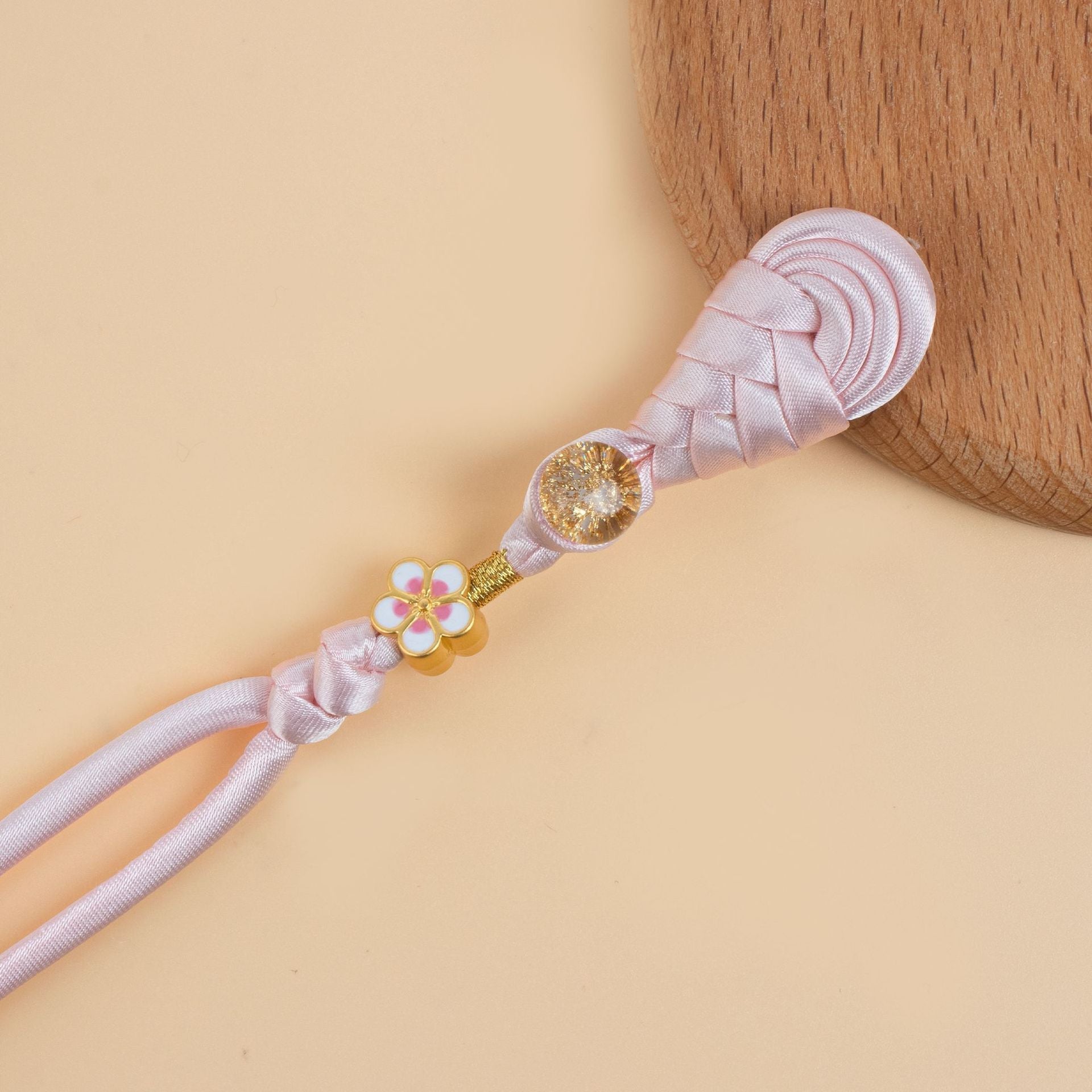 Pink braided frog button strand with gold flower charm and glitter round bead