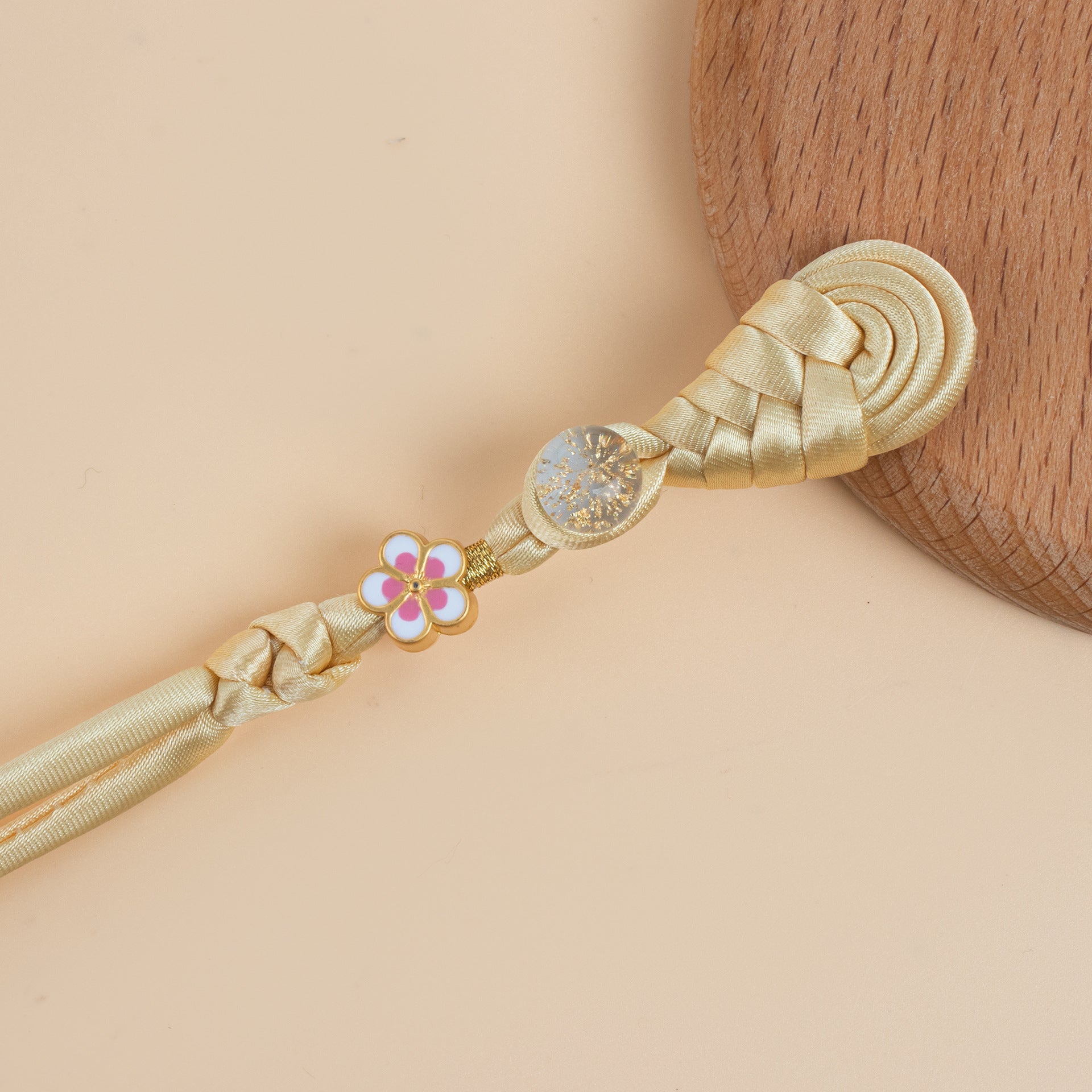 Beige braided frog button strand with gold flower charm and glitter round bead