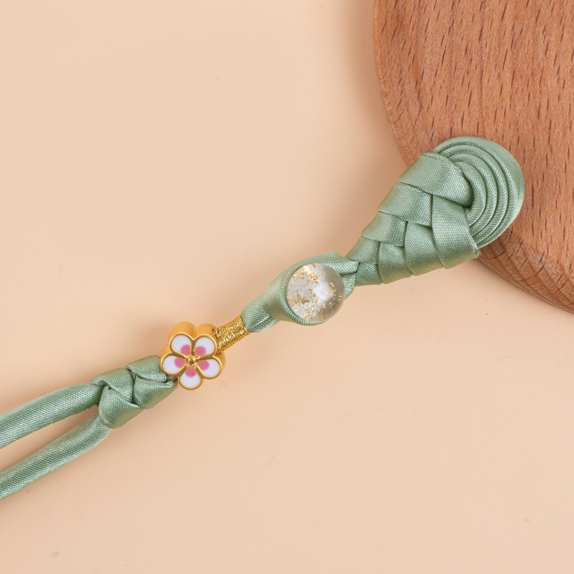 Green braided frog button strand with gold flower charm and glitter round bead, end cap
