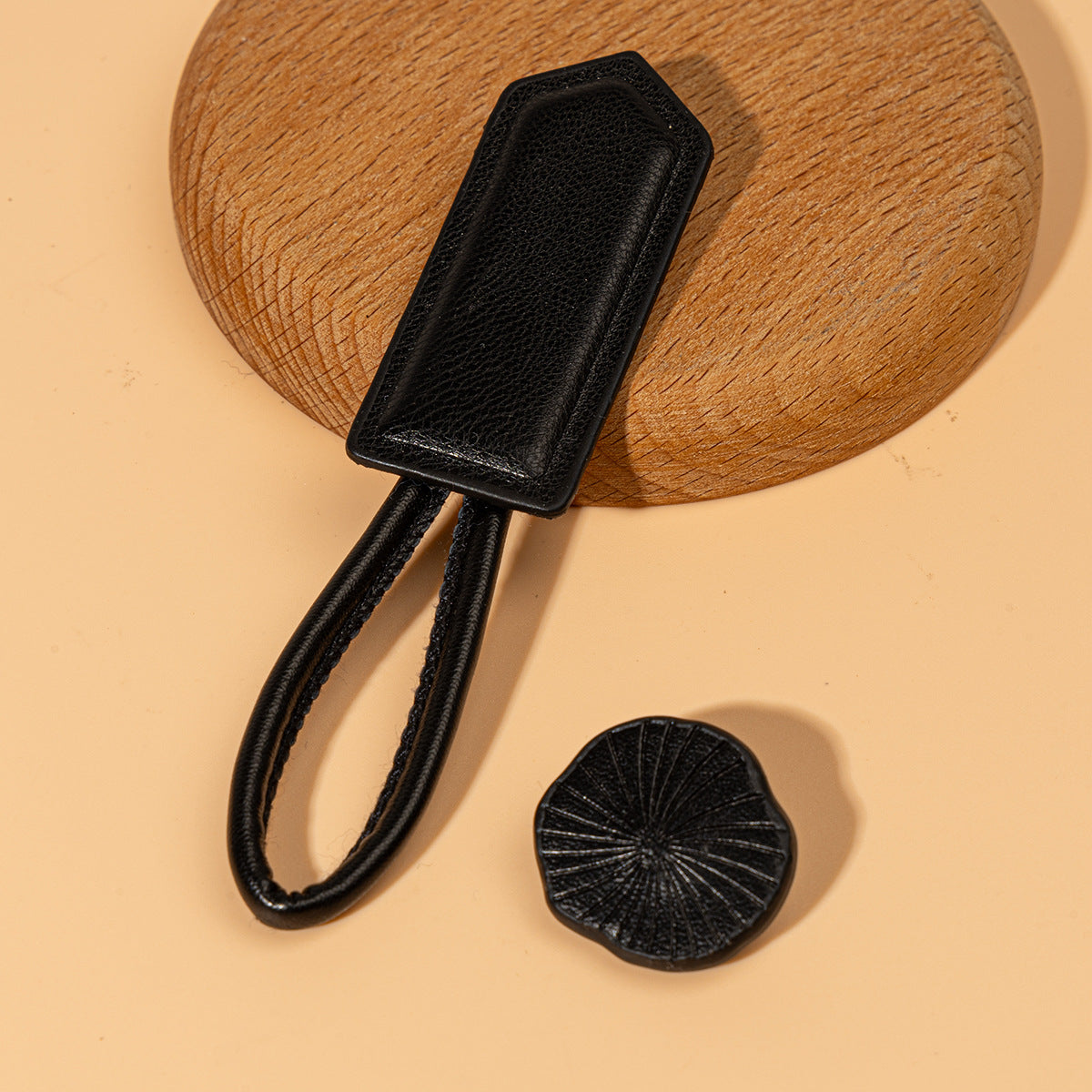 Black leather Chinese knot button with textured oval plate and round disc