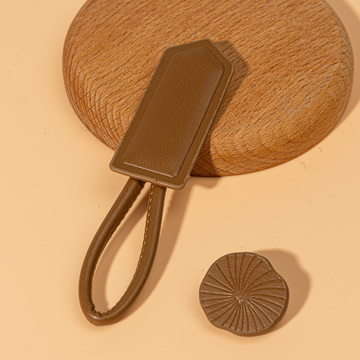 Brown leather Chinese knot button with oval plate and matching round disc