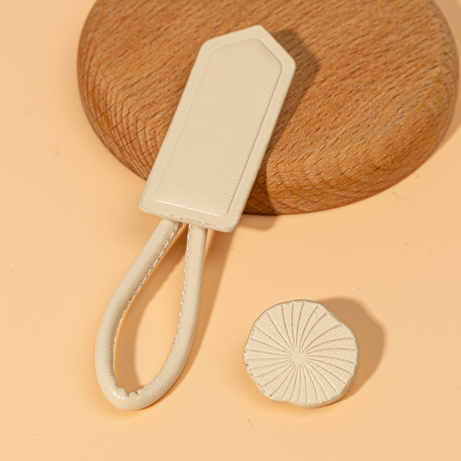 Beige leather Chinese knot button with oval plate and round textured disc