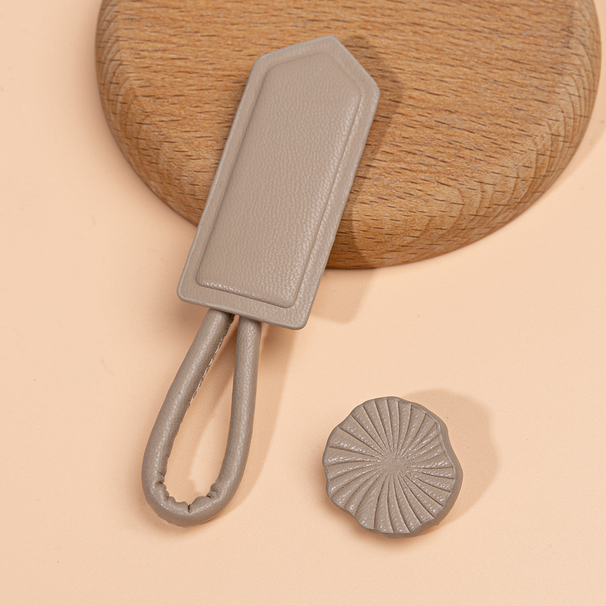 Grey leather Chinese knot button with oval plate and round textured disc