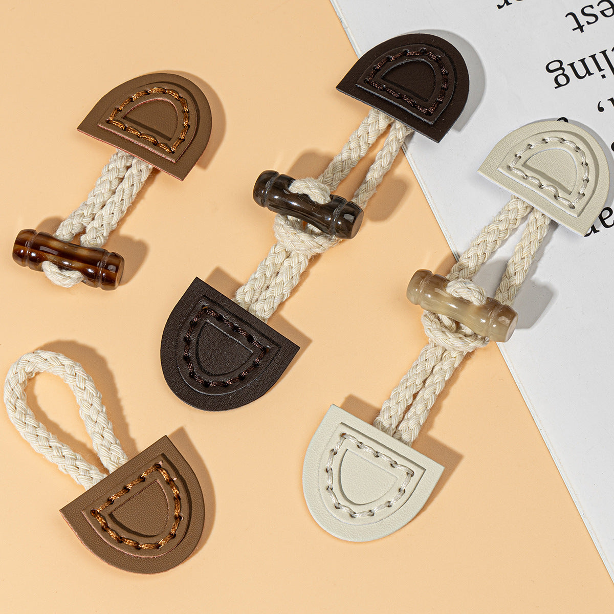 Leather sew-on toggles in beige, brown, and dark coffee with braided cords and rings