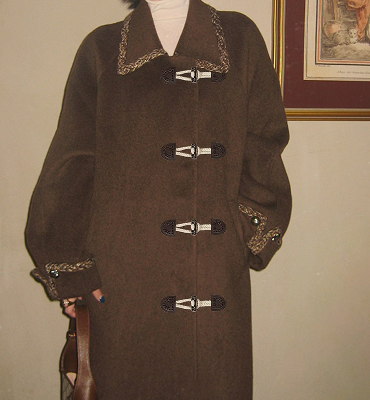 Dark coffee leather sew-on toggles on dark coat placket with braided trim