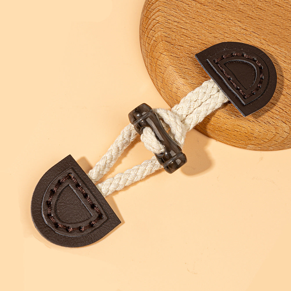 Dark coffee leather sew-on toggle with white braided cord and dark ring fastener