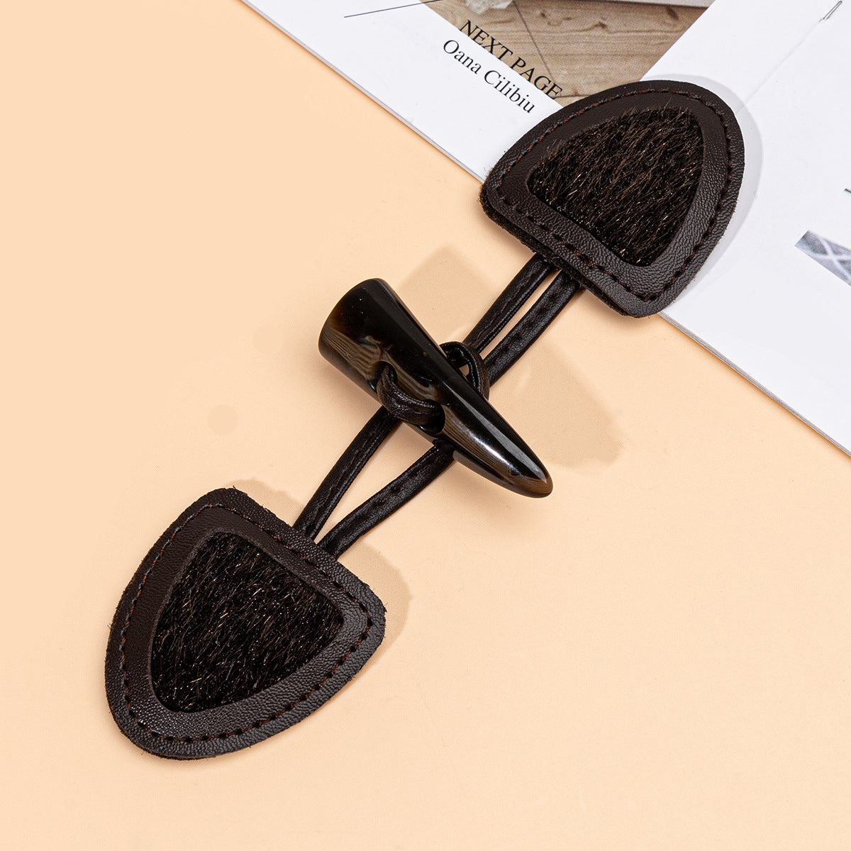 Dark coffee leather sew-on toggle with resin horn button, white center panel