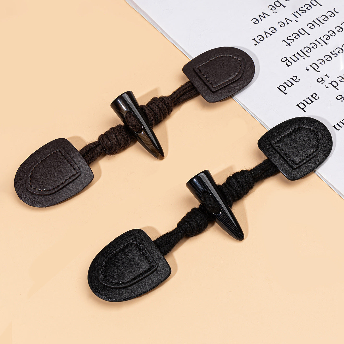 Black leather sew-on buttons with resin horn spikes and braided cord, multiple pairs