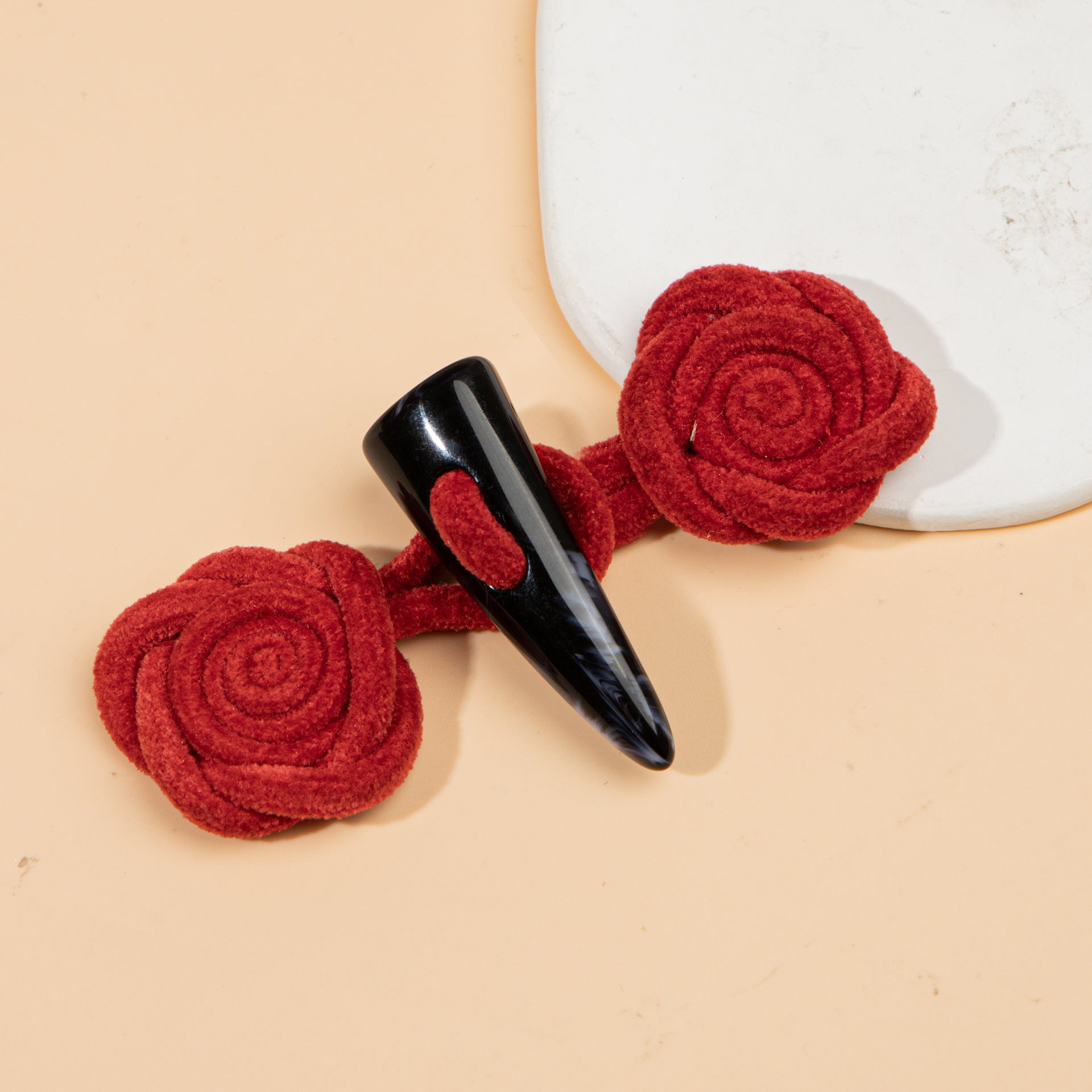 Corduroy rose sew-on toggle buttons in red with black resin horn tips