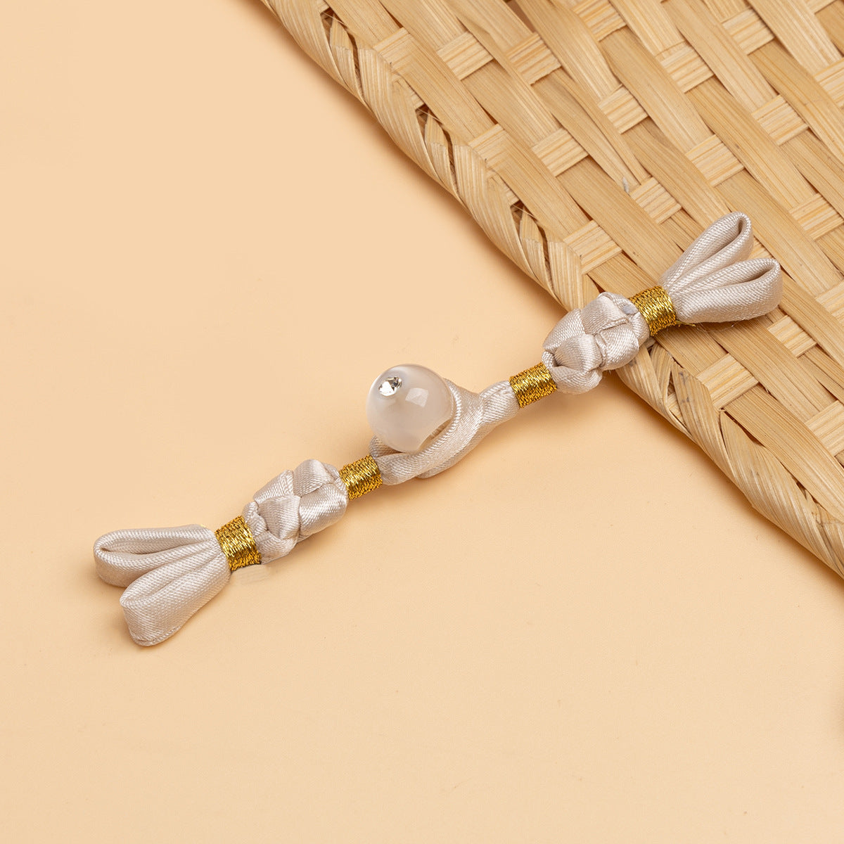 White & gold cheongsam panko with braided cords and pearl-like round stone button