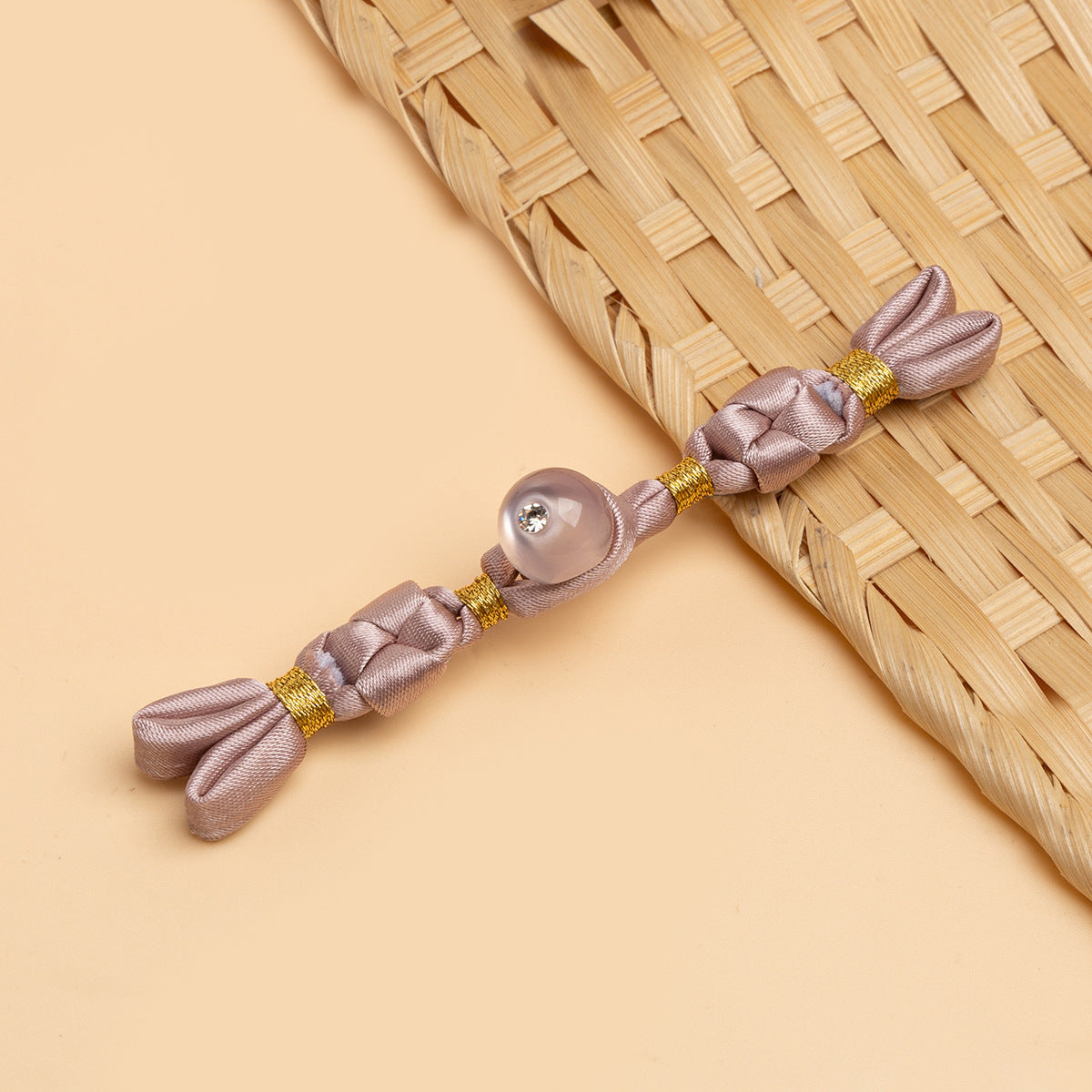 Light pink cheongsam panko with braided cords and mauve round stone button
