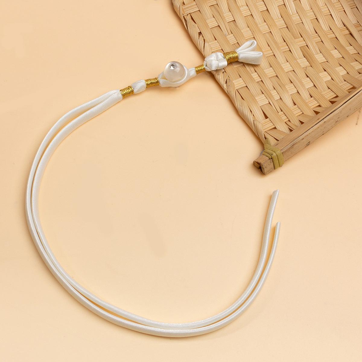 White cheongsam panko cord with knot detail and clear round stone button