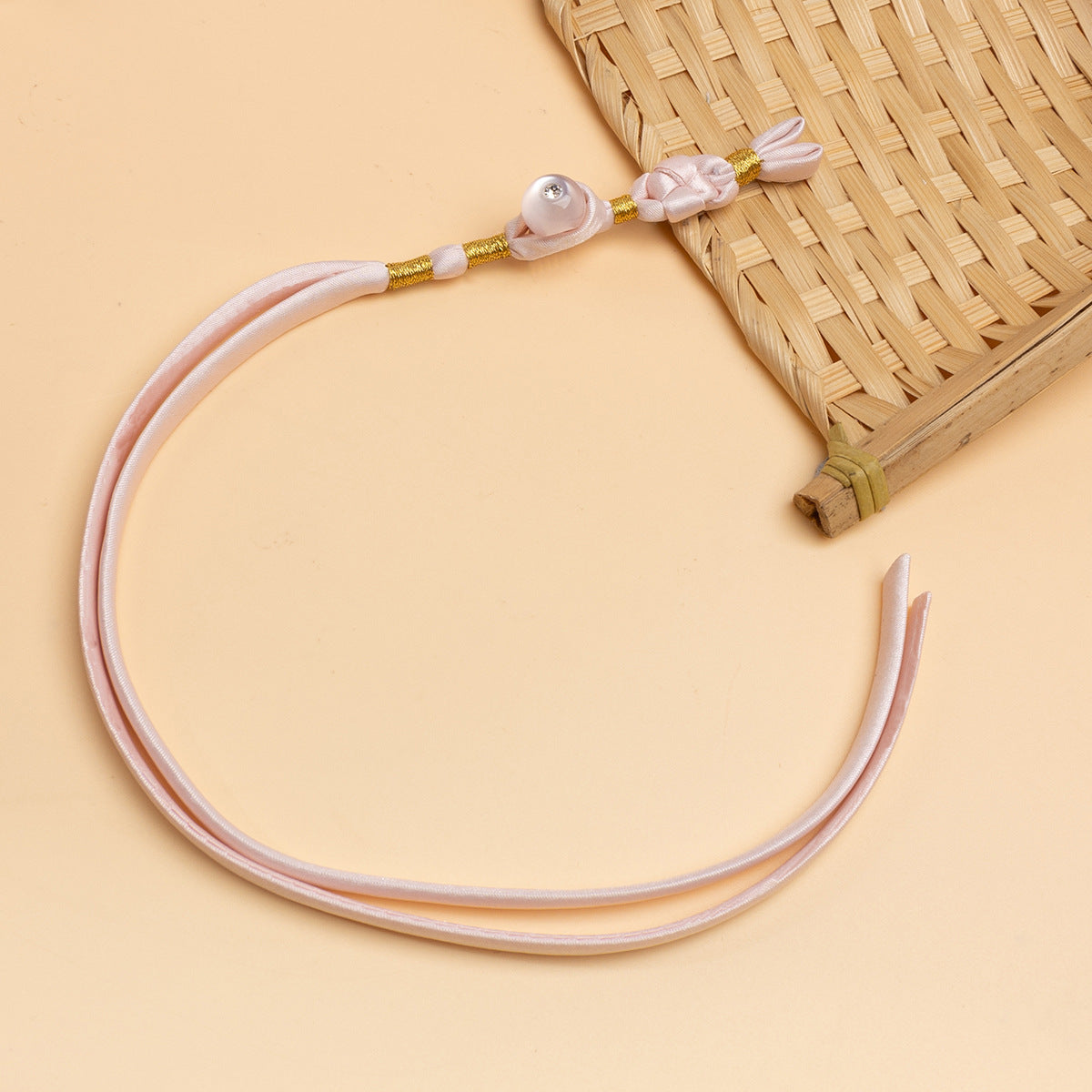 Light pink cheongsam panko cord with bow detail and clear round stone button