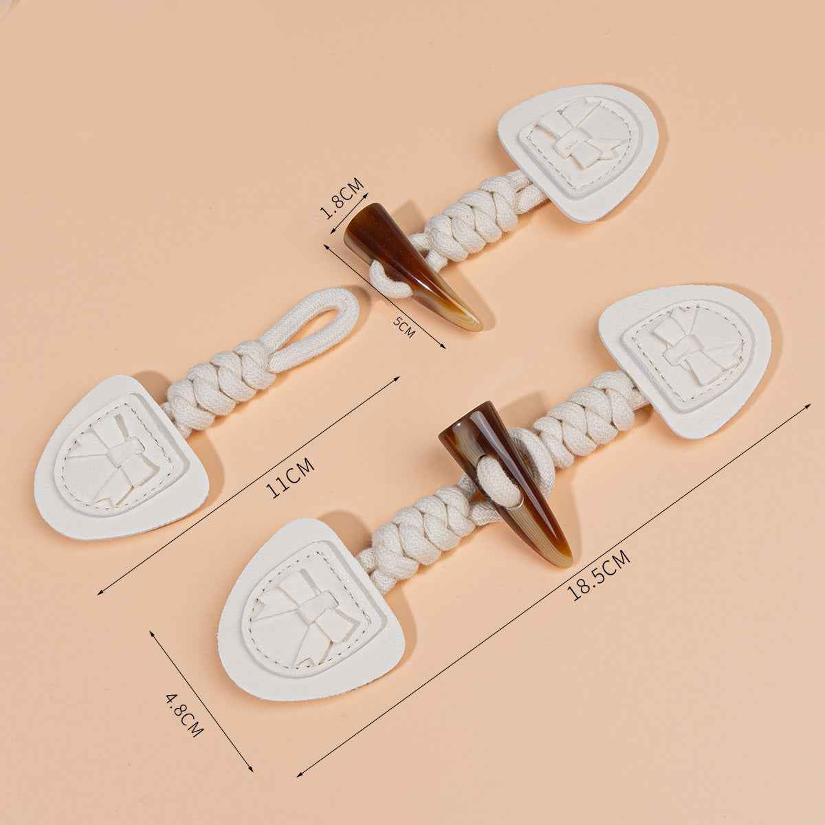 18.5cm coat buckle set with measurements; braided cords with heart-shaped leather pads