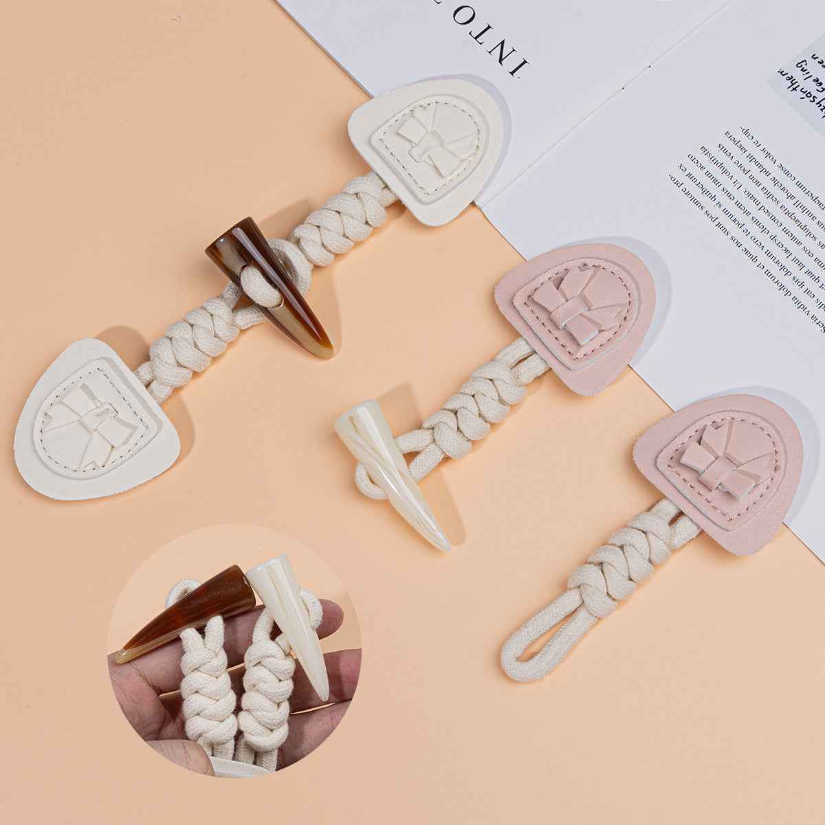 Coat buckle bundle with braided cords and horn tips, showing pink and white heart pads