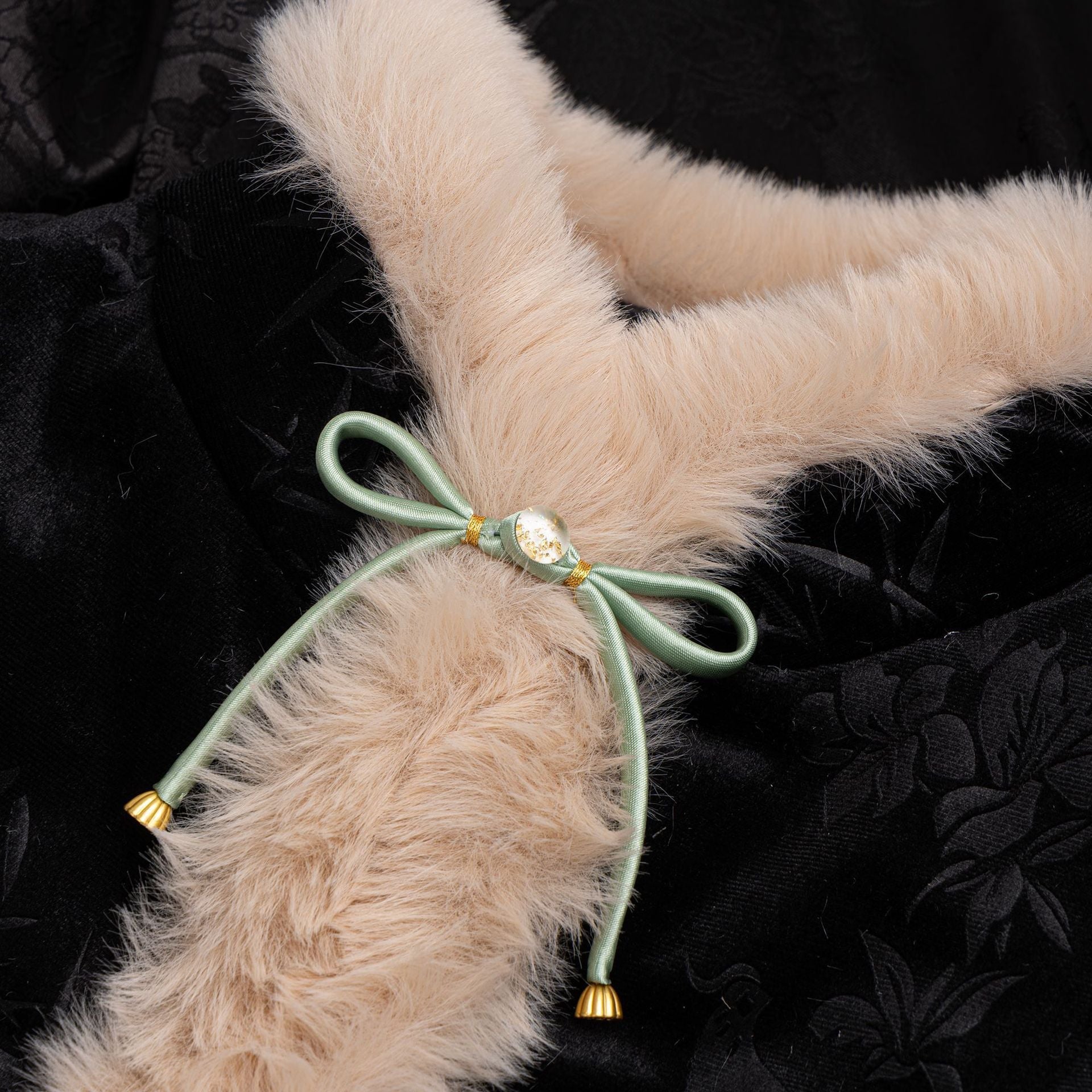 Satin bowknot button with mint-green ribbon, gold center and tassel ends