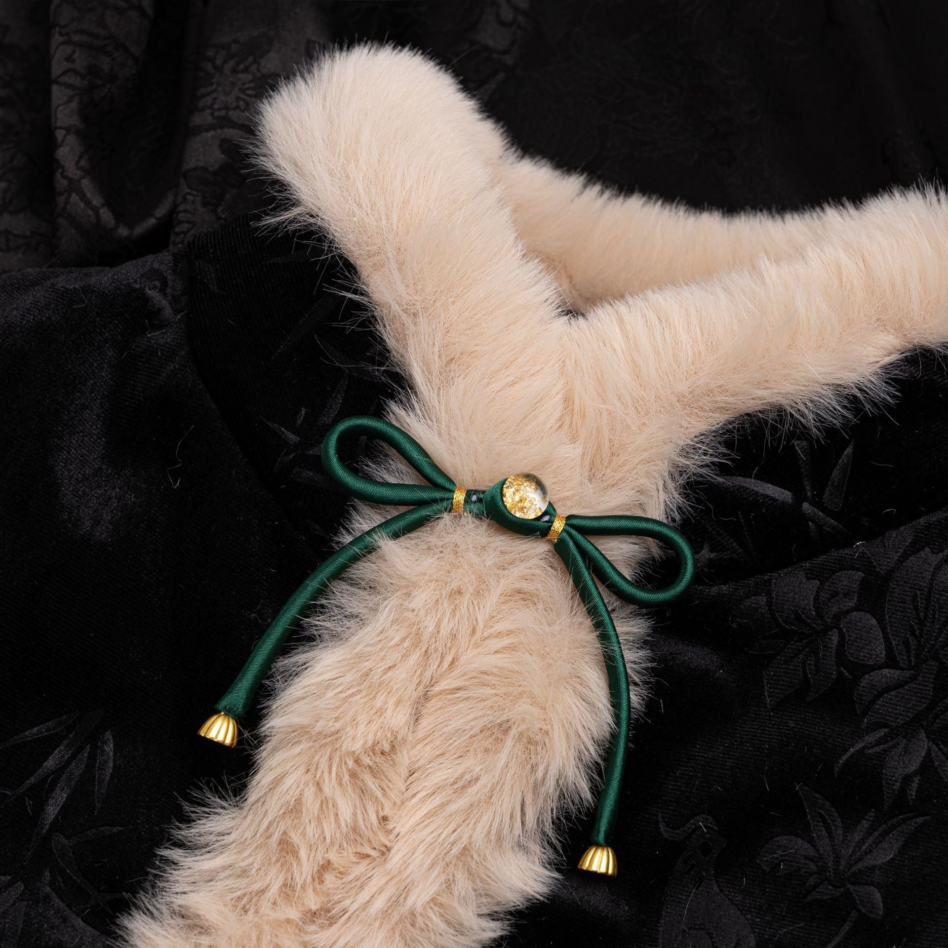 Satin bowknot button with dark-green ribbon, gold center and tassel ends