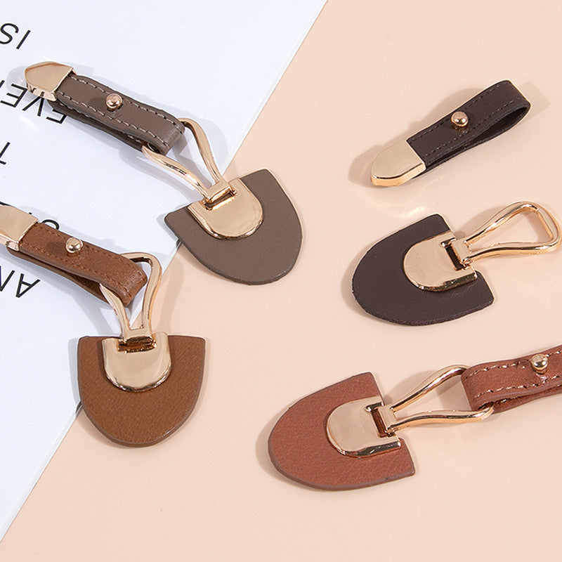 Assorted coffee and beige leather sew-on toggles with gold metal buckles (set)