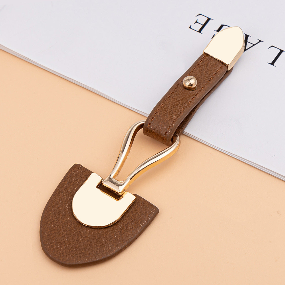 Medium brown leather sew-on toggle with gold metal buckle and rivet
