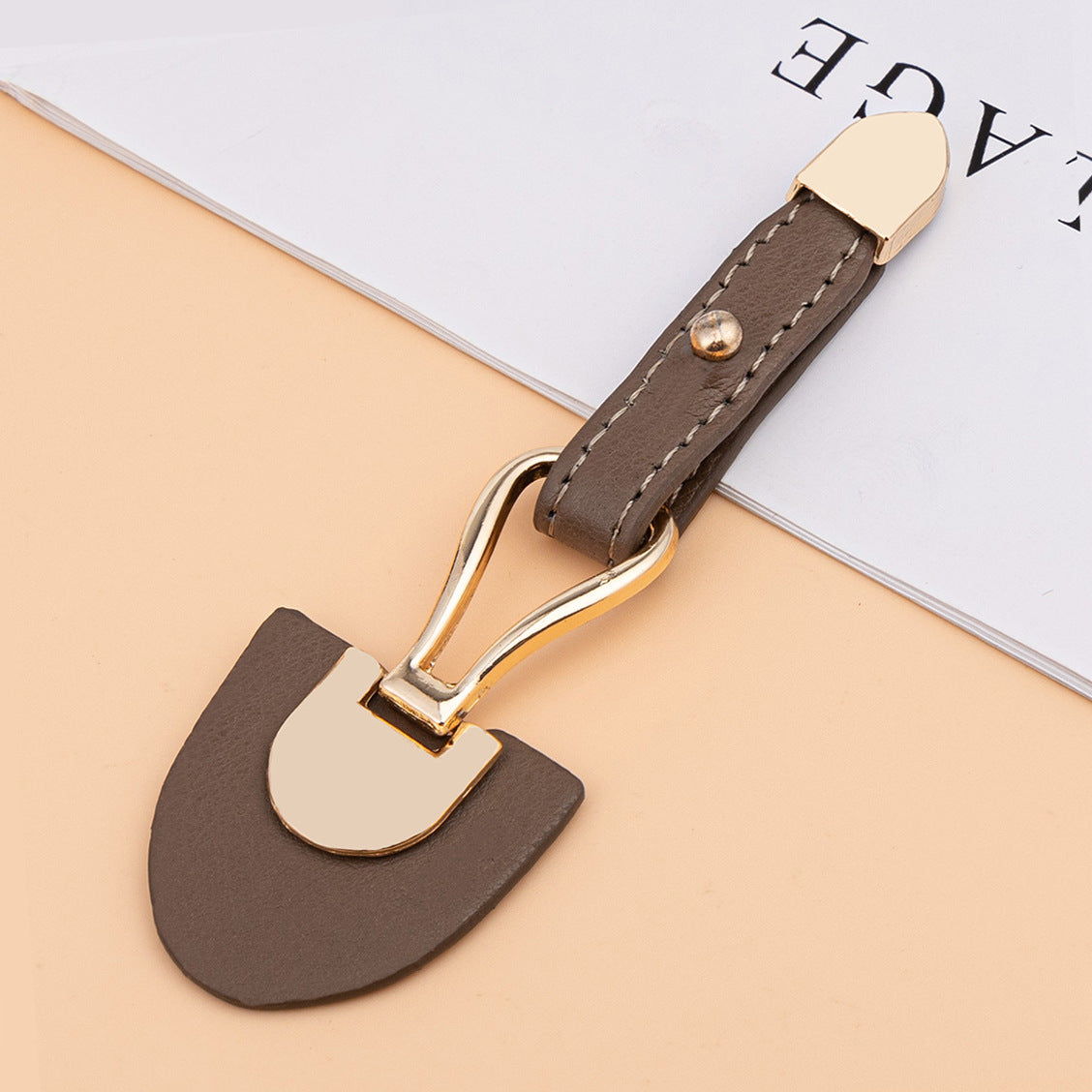 Dark coffee leather sew-on toggle with gold metal buckle and rivet