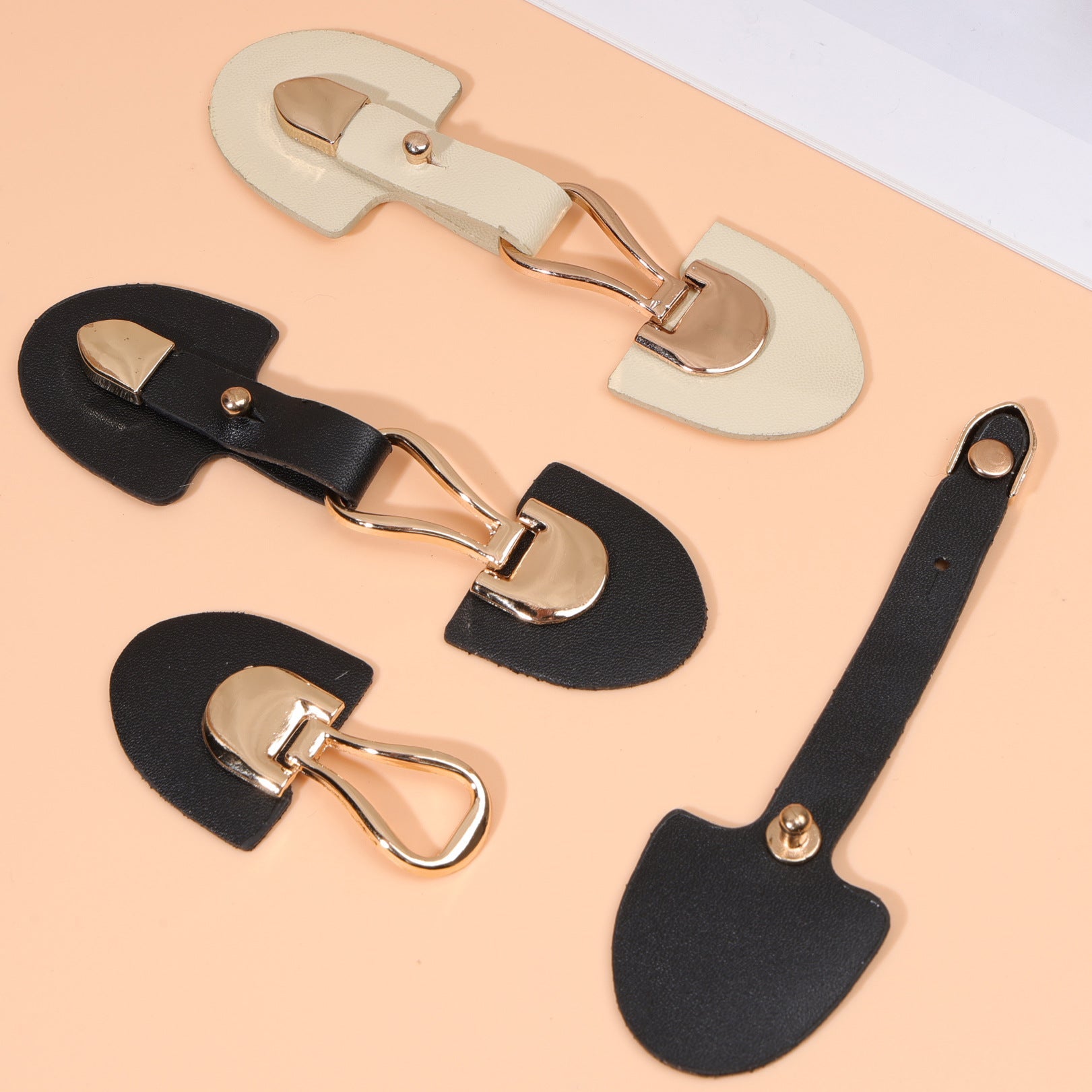 6 pcs leather sew-on toggles in black and beige with metal buckles