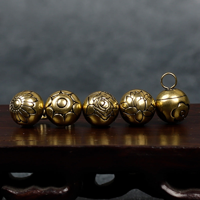 Set of decorative copper buttons with embossed floral and swirl motifs and looped backs