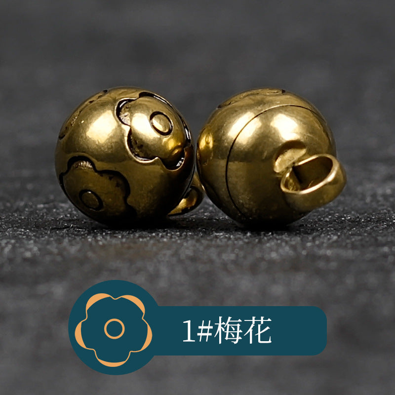 Copper metal buttons with scroll/cloud-like front motif and looped shank back
