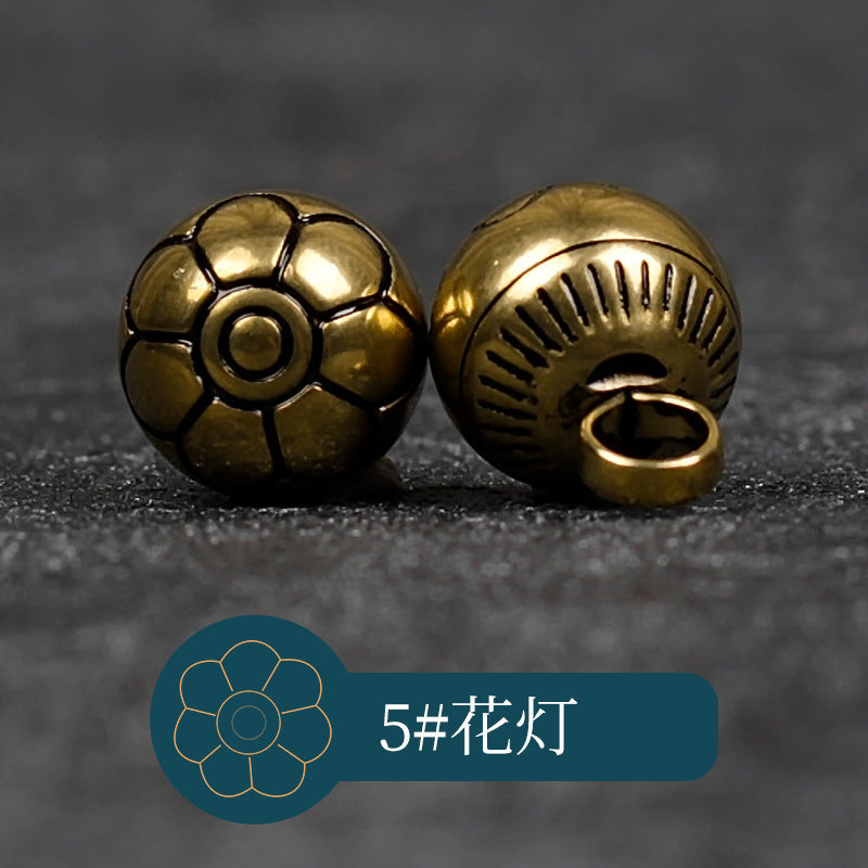 Copper metal button with petal flower front detail and oval loop shank back