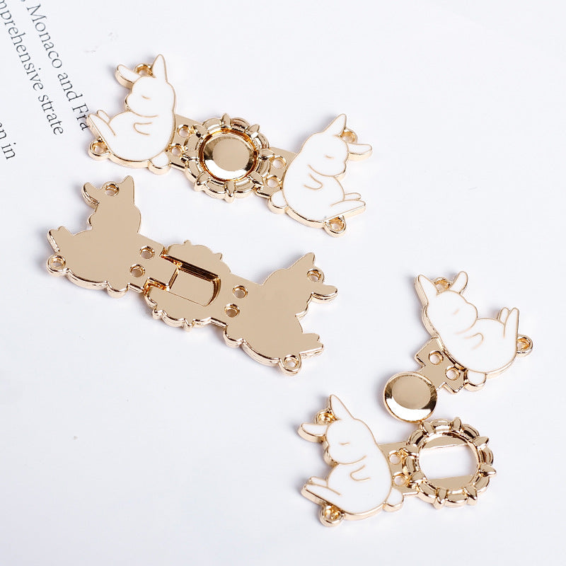 Assorted light gold rabbit buttons with white enamel, circular filigree centers and loops